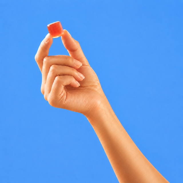 Hand holding a PureKana Sleep Gummy